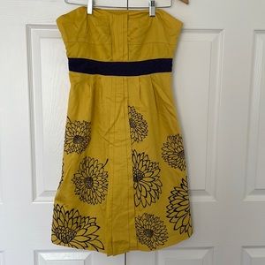 Gold dress with dark purple accents.